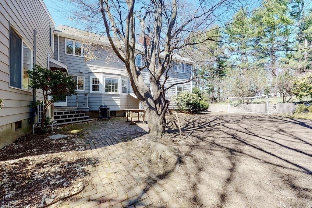 5 Spring Valley Road Belmont, MA 02478 - Photo 32 of 40 a view of a yard with a large tree