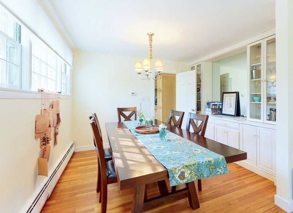 5 Spring Valley Road Belmont, MA 02478 - Photo 8 of 40 a dining room with furniture a chandelier and wooden floor