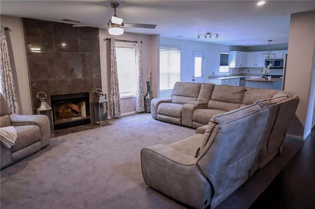 5964 Springfair Run Lithonia, GA 30038 - Photo 13 of 40 a living room with furniture and a fireplace