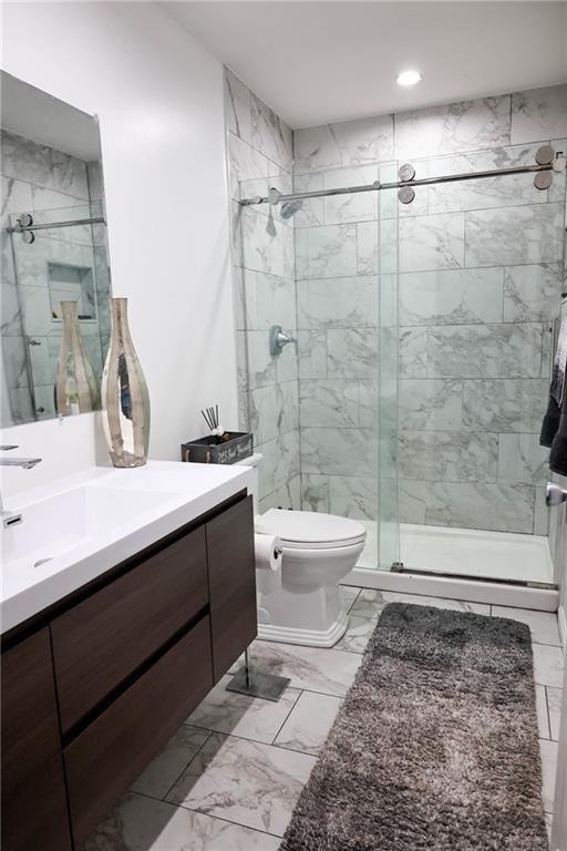 5964 Springfair Run Lithonia, GA 30038 - Photo 19 of 40 a bathroom with a sink a toilet and shower