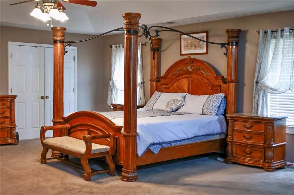 5964 Springfair Run Lithonia, GA 30038 - Photo 22 of 40 a bedroom with a bed and wooden floor