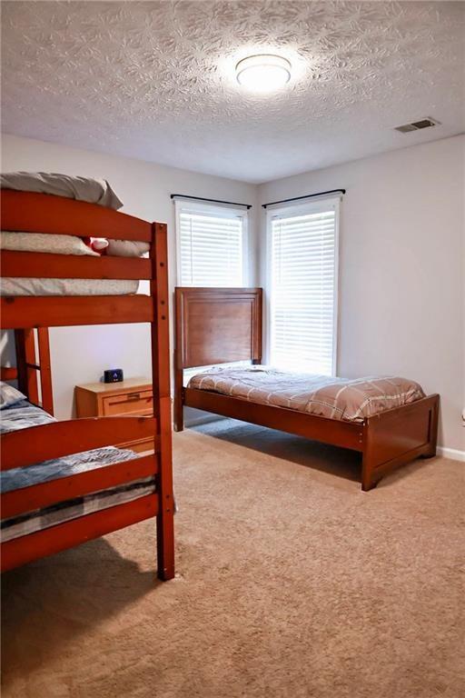 5964 Springfair Run Lithonia, GA 30038 - Photo 29 of 40 a bedroom with a bed and a window