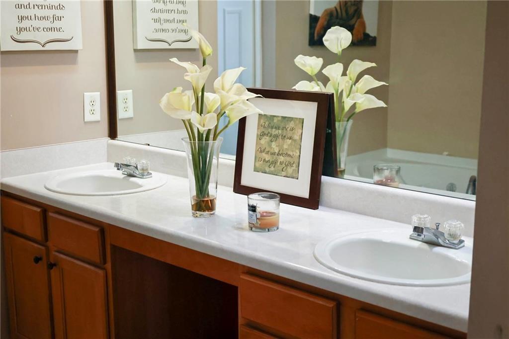 5964 Springfair Run Lithonia, GA 30038 - Photo 30 of 40 a bathroom with a sink double vanity and a mirror