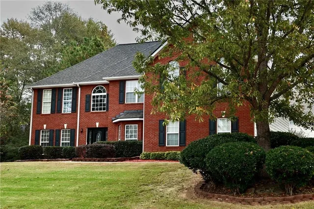 a front view of a house with a yard