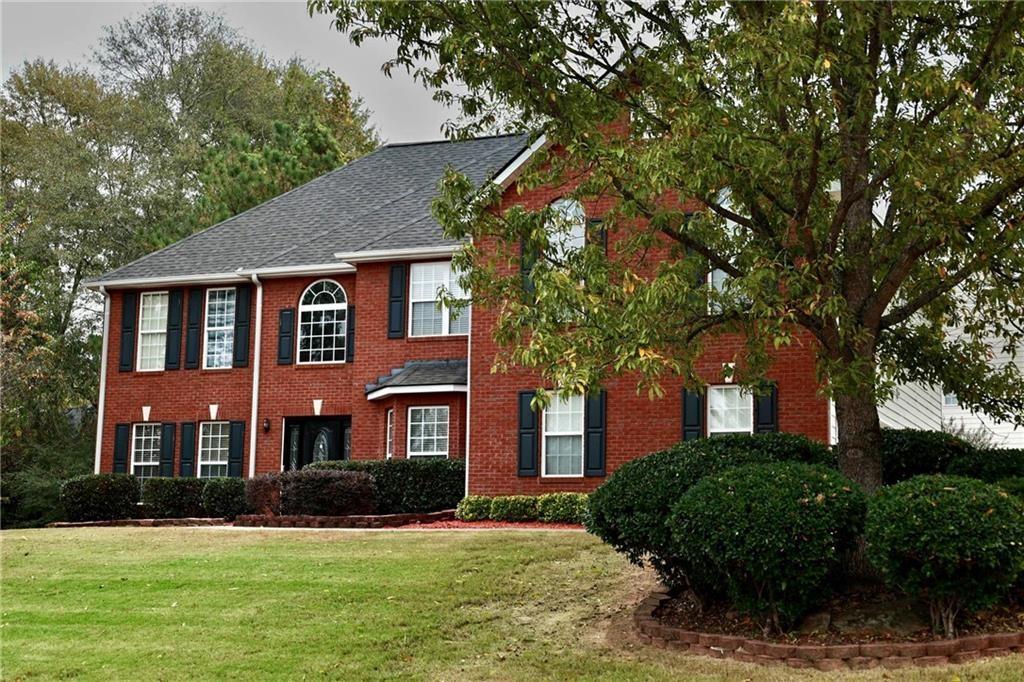 5964 Springfair Run Lithonia, GA 30038 - Photo 3 of 40 a front view of a house with a yard