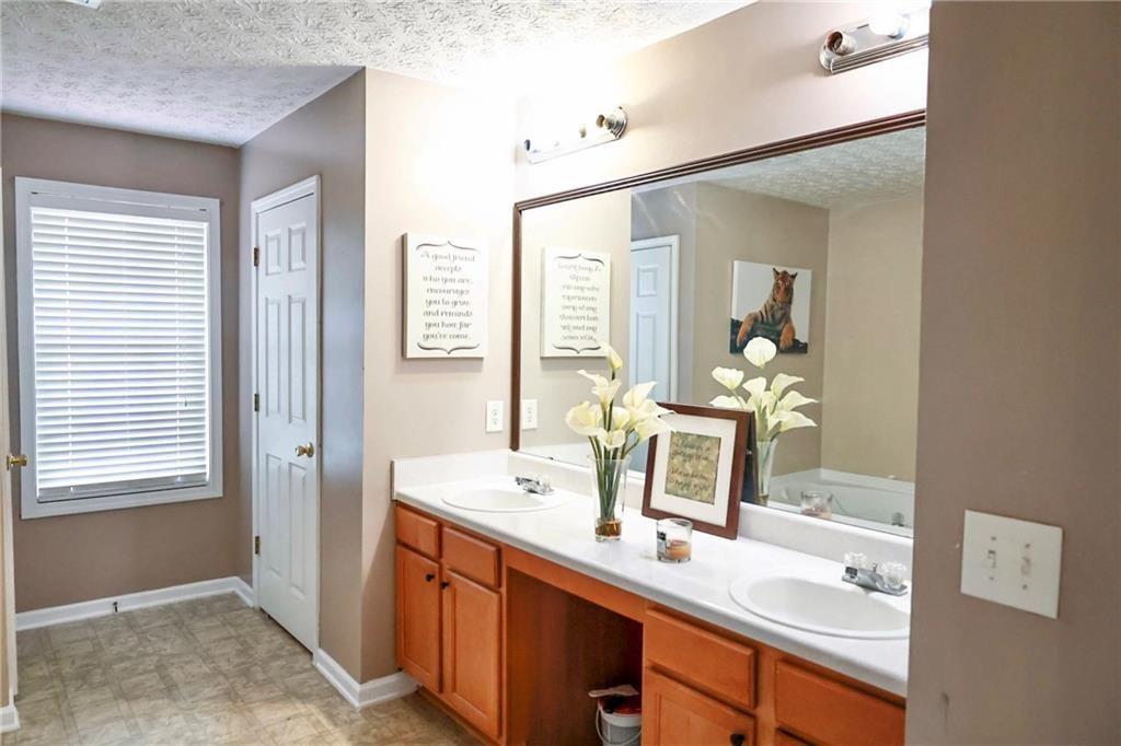 5964 Springfair Run Lithonia, GA 30038 - Photo 32 of 40 a bathroom with a sink double vanity and a mirror