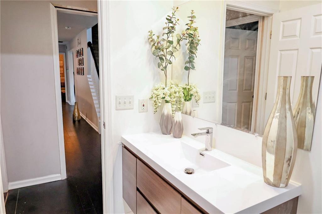 5964 Springfair Run Lithonia, GA 30038 - Photo 33 of 40 a bathroom with a sink vanity and a mirror