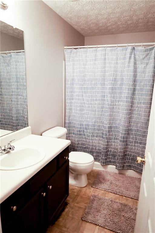 5964 Springfair Run Lithonia, GA 30038 - Photo 34 of 40 a bathroom with a sink a toilet and shower