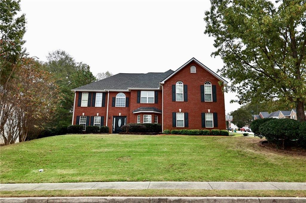 5964 Springfair Run Lithonia, GA 30038 - Photo 37 of 40 a front view of a house with a yard