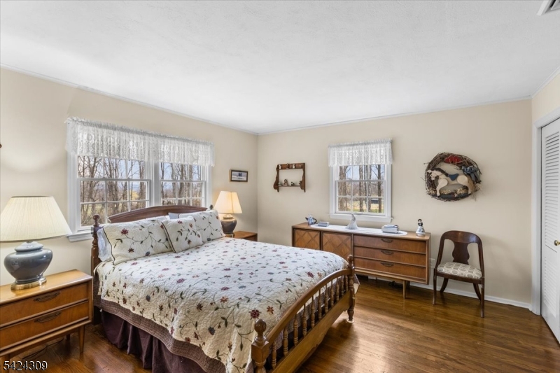 58 Andover Road Sparta, NJ 07871 - Photo 19 of 38 a bedroom with a large bed and a table in it
