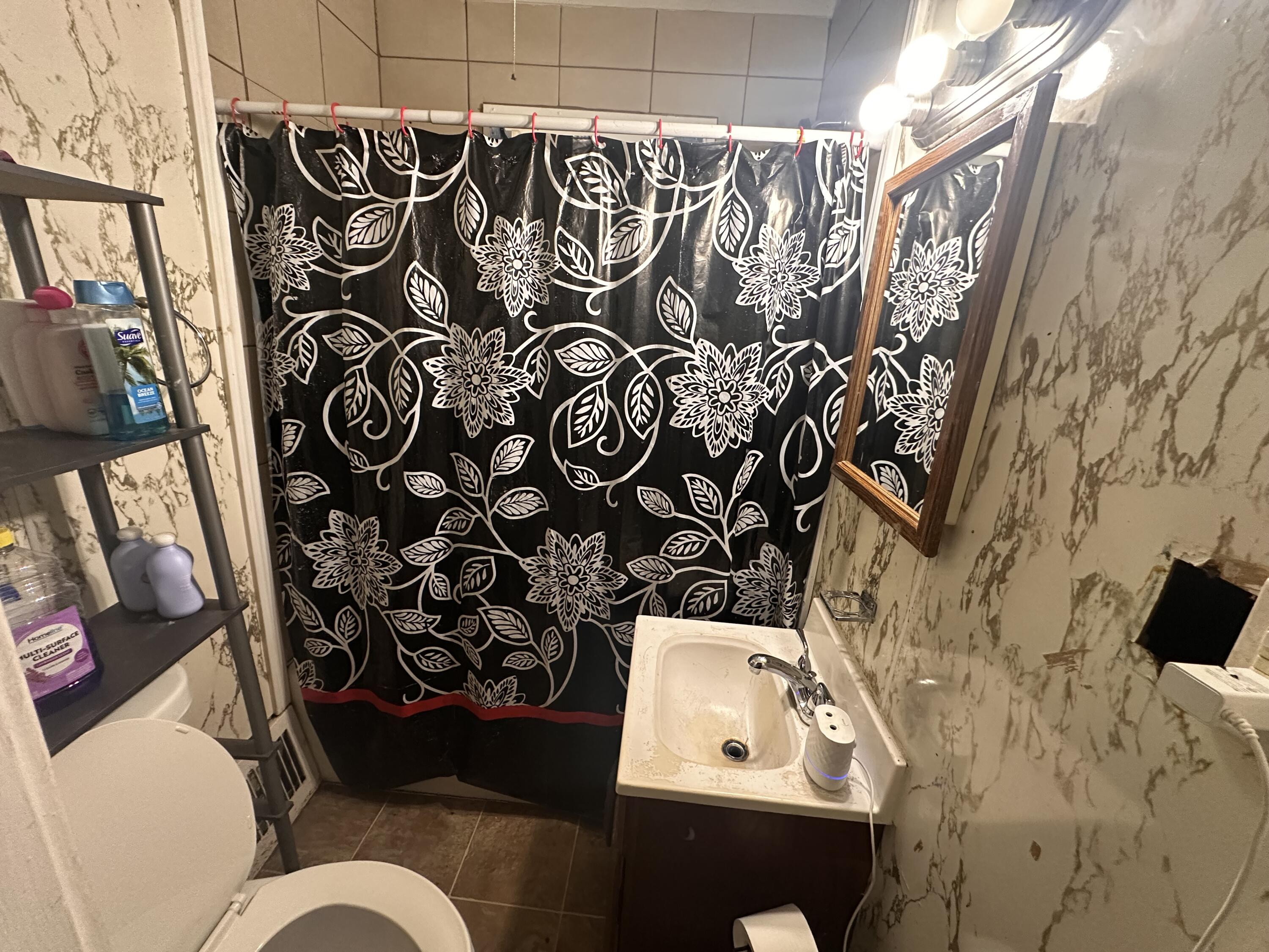 3756 Tyler Street Gary, IN 46408 - Photo 11 of 12 a bathroom with a toilet and a shower curtain