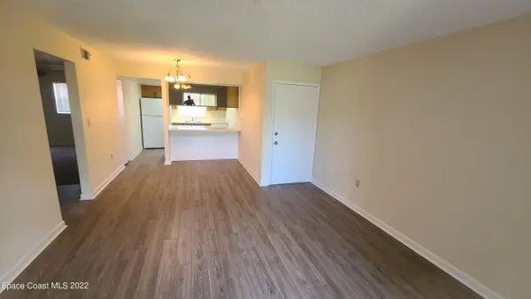 a view of a kitchen from a hallway