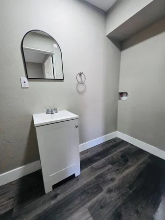 a utility room with wooden floor washer and dryer