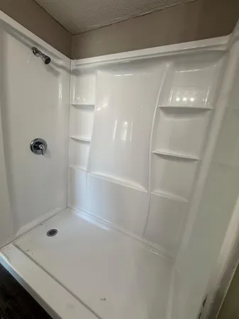 a bathroom with a glass shower door