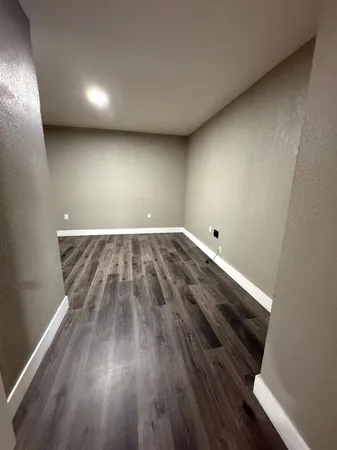 a view of room with wooden floor