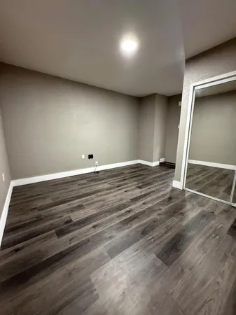 an empty room with wooden floor