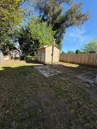 a view of backyard of house with green space
