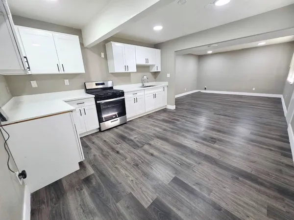 a kitchen with wooden floors and white appliances