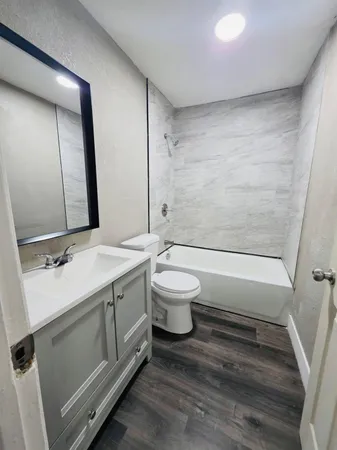 a bathroom with a double vanity sink toilet and shower