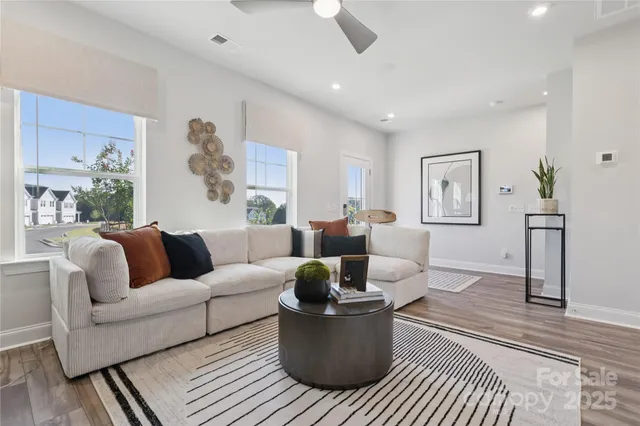 a living room with furniture and a potted plant