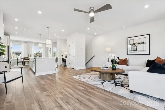 a living room with furniture and kitchen view