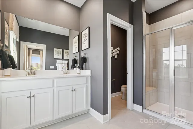 a bathroom with a double vanity sink and a mirror