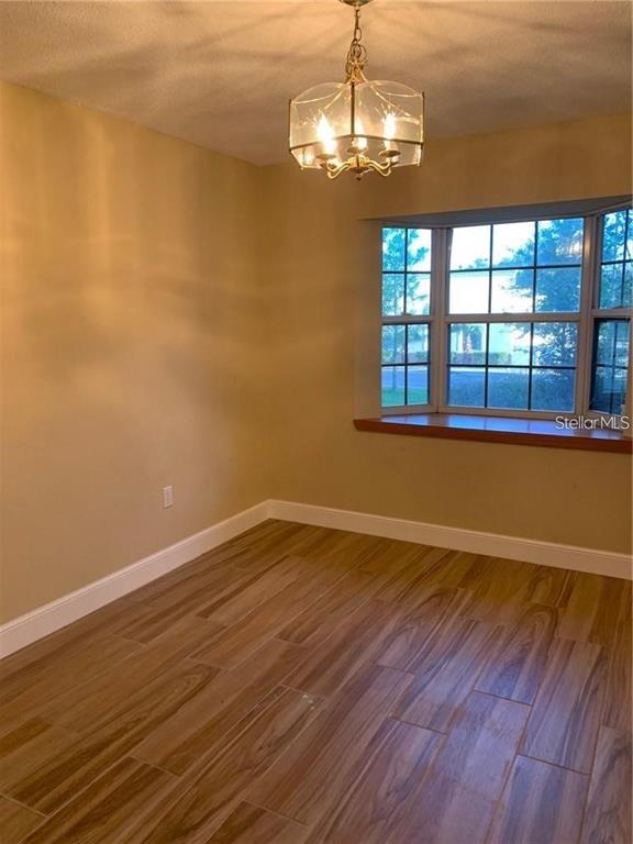 3090 Sunset Point Road Clearwater, FL 33759 - Photo 13 of 14 a view of empty room with wooden floor and fan