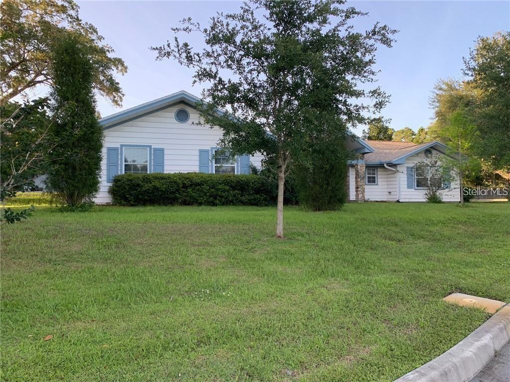 3090 Sunset Point Road Clearwater, FL 33759 - Photo 15 of 16 a front view of house with yard and green space