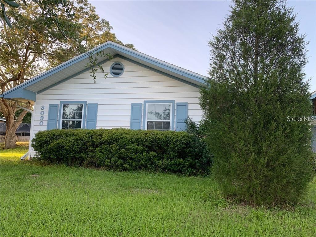 3090 Sunset Point Road Clearwater, FL 33759 - Photo 16 of 16 a front view of house with yard and green space
