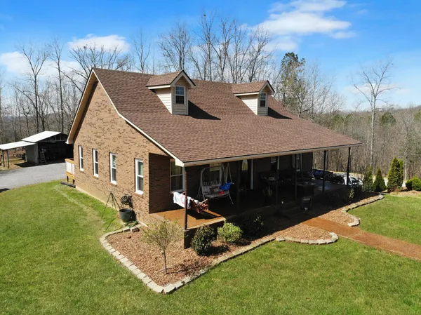 a front view of a house with a yard balcony