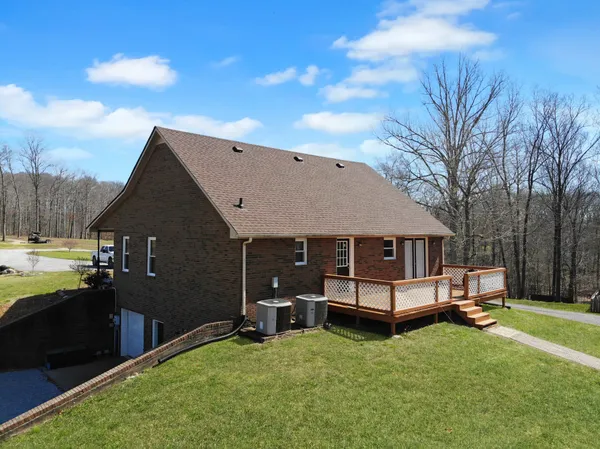 a view of a house with a yard and wooden fence