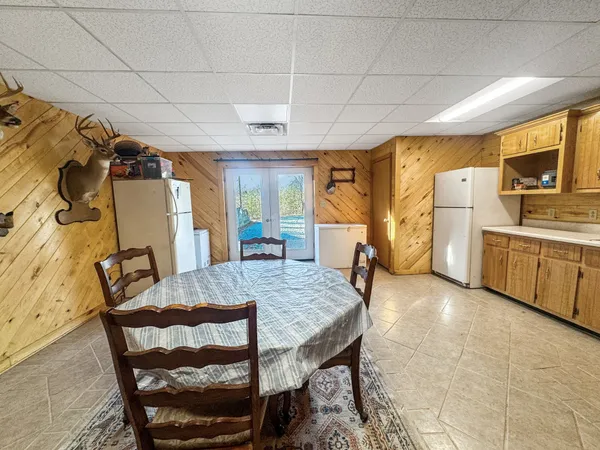 a view of a dining room with furniture and chandelier