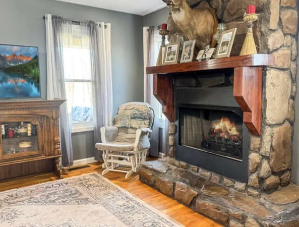a living room with furniture a fireplace and a flat screen tv
