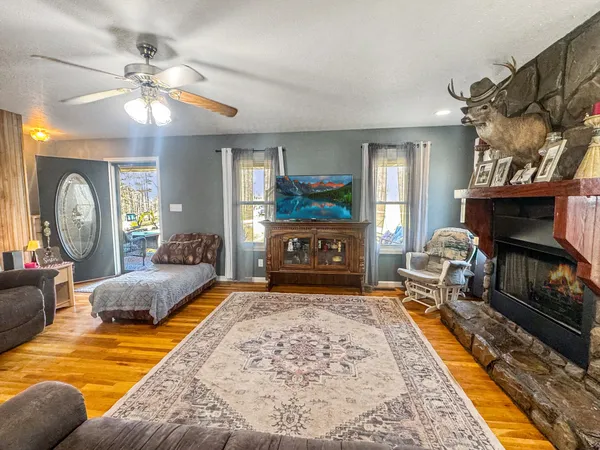 a living room with furniture a fireplace and a chandelier