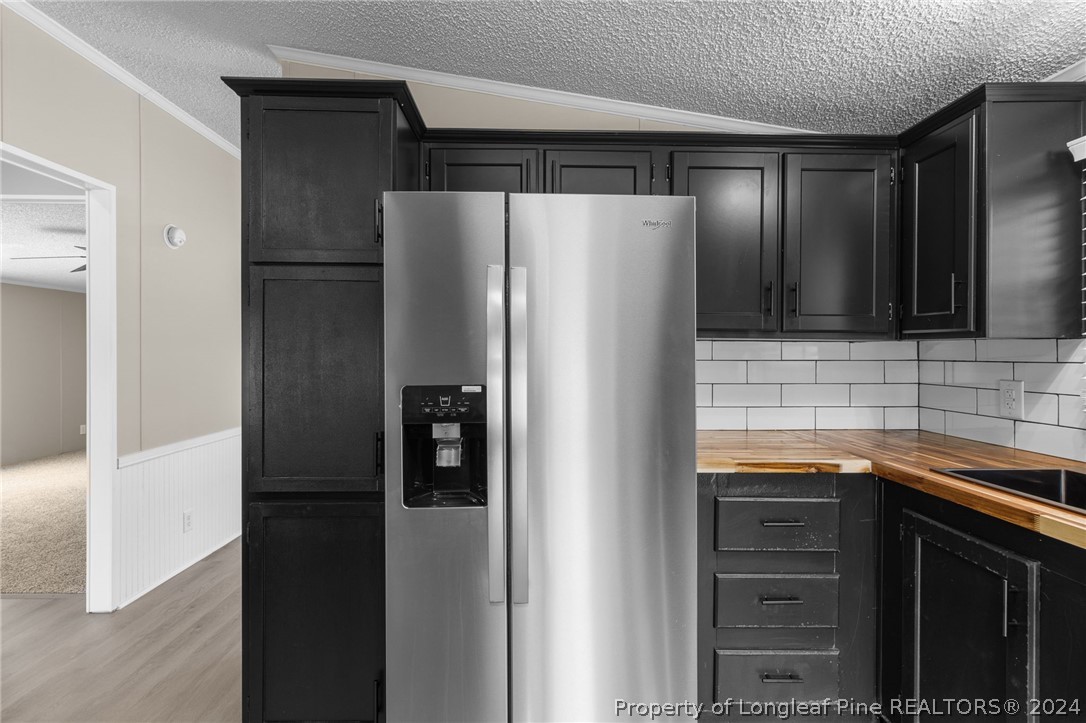 8002 Fayetteville Road Godwin, NC 28344 - Photo 27 of 40 a metallic refrigerator freezer sitting in a kitchen