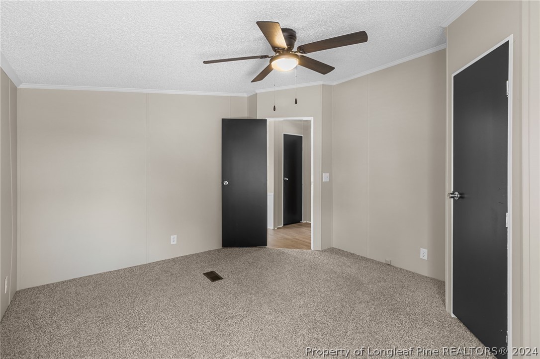 8002 Fayetteville Road Godwin, NC 28344 - Photo 34 of 40 an empty room with a ceiling fan and a window