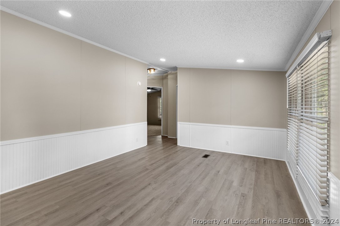 8002 Fayetteville Road Godwin, NC 28344 - Photo 10 of 40 a view of an empty room with wooden floor