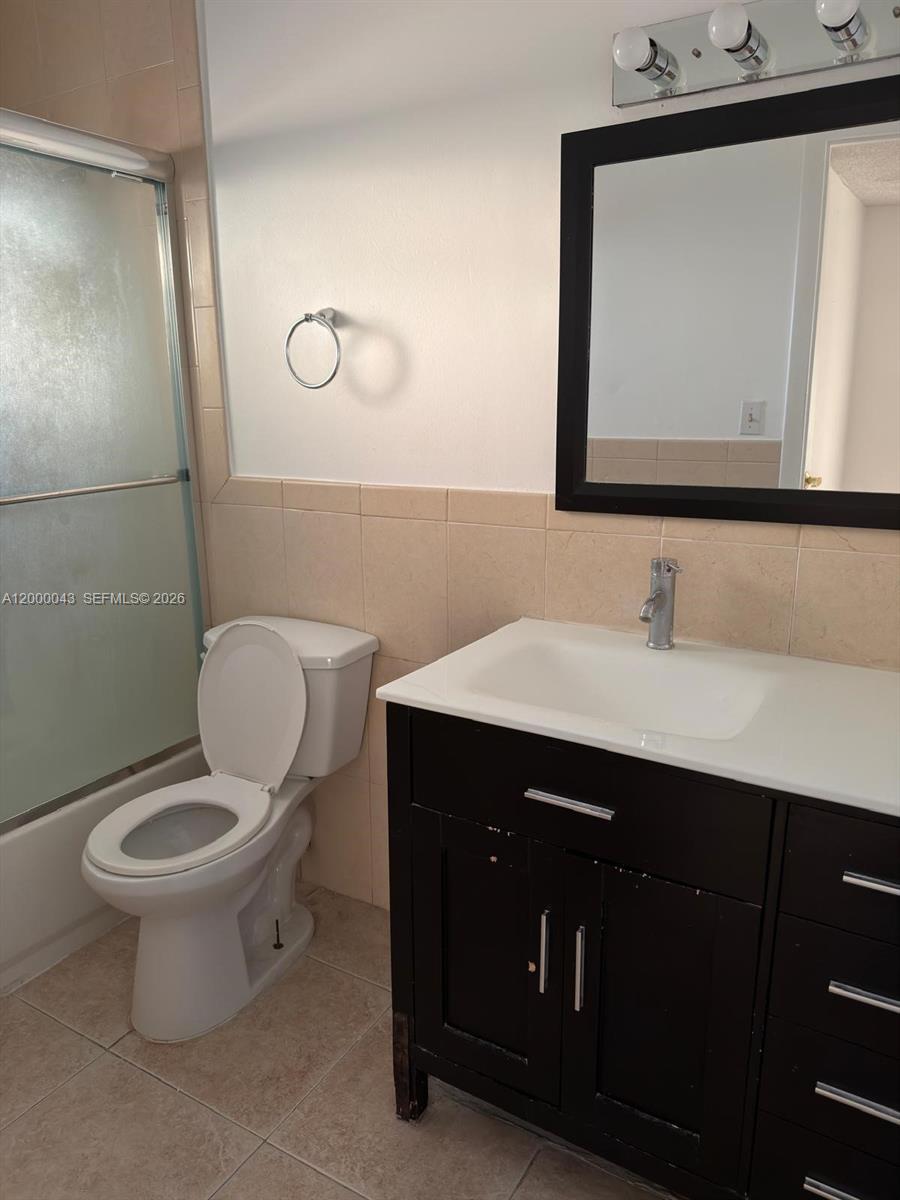 9108 Southwest 137th Street, Unit 163 Miami, FL 33176 - Photo 11 of 16 a bathroom with a toilet sink and mirror