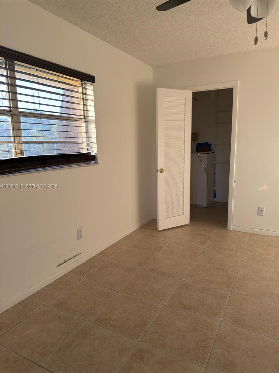 9108 Southwest 137th Street, Unit 163 Miami, FL 33176 - Photo 14 of 16 a view of an empty room with a window