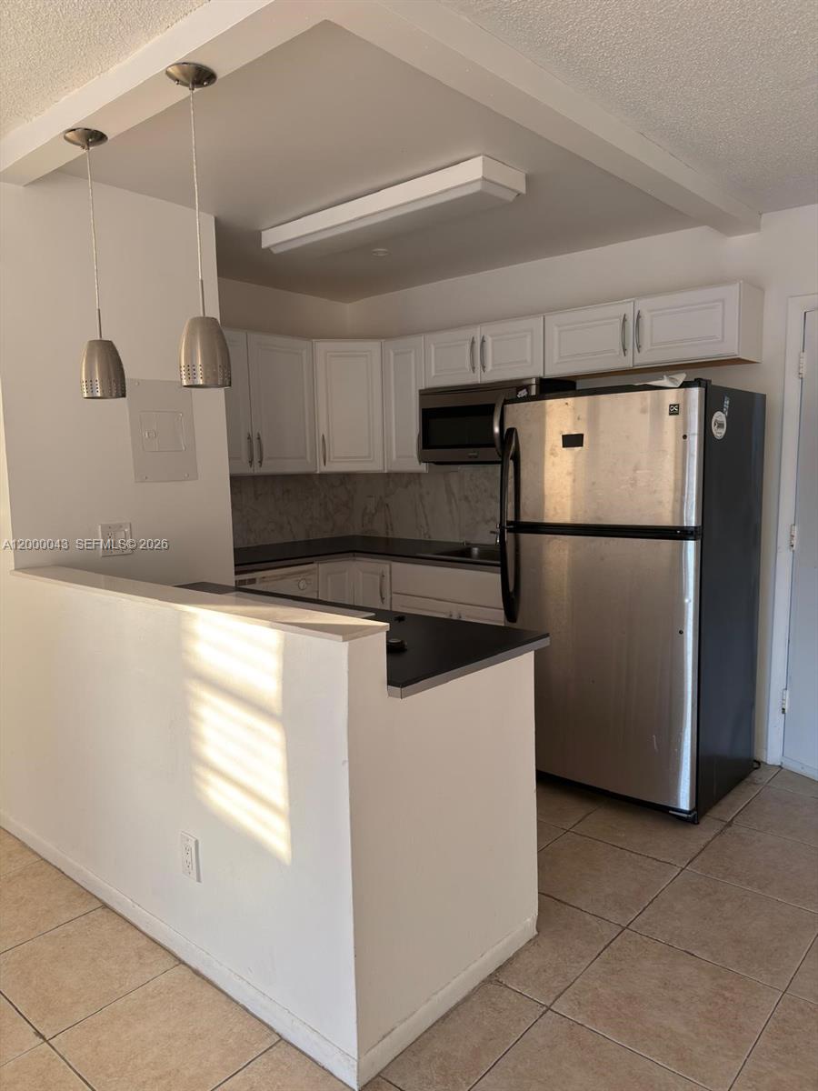 9108 Southwest 137th Street, Unit 163 Miami, FL 33176 - Photo 15 of 16 a kitchen with refrigerator and window