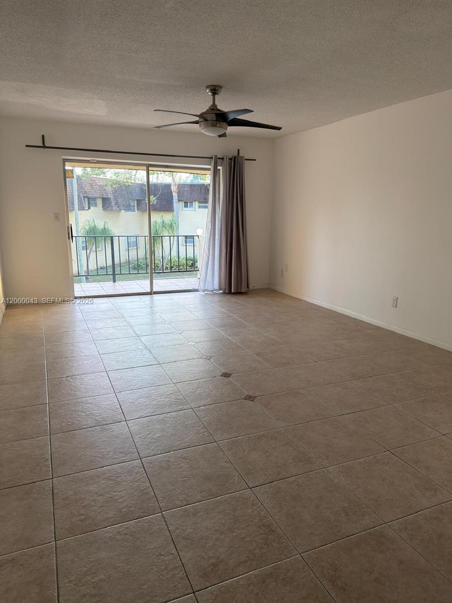 9108 Southwest 137th Street, Unit 163 Miami, FL 33176 - Photo 2 of 16 a view of a livingroom with a floor to ceiling window and an outdoor view