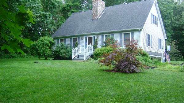 31 Webber Road Brookfield, MA 01506 - Photo 1 of 1 a front view of house with yard and green space
