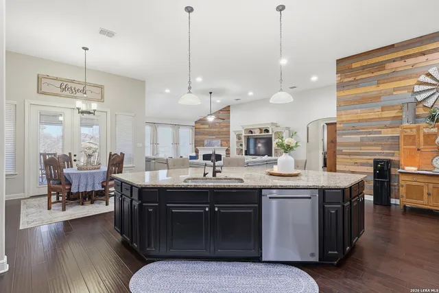 a kitchen with stainless steel appliances granite countertop stove top oven and cabinets