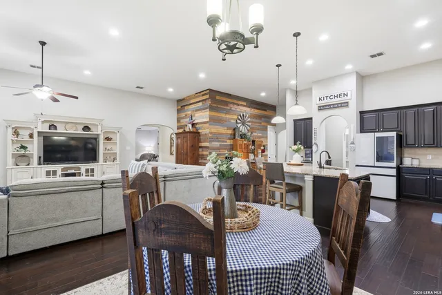 a large kitchen with a table and chairs