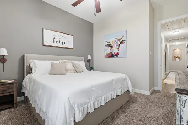 a bedroom with bed and a chandelier