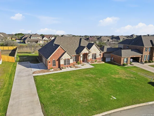 an aerial view of a house with swimming pool garden view and a lake view