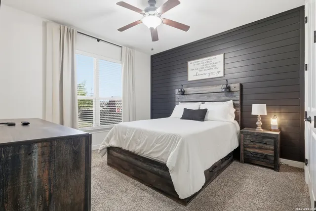 a bedroom with a bed and a window