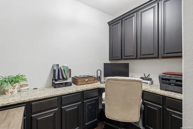 a room with a sink cabinets and wooden floor