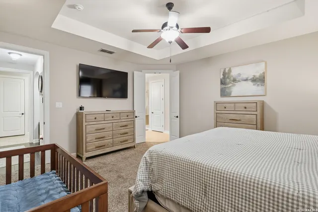 a bedroom with a bed and a chandelier