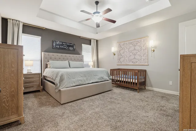 a spacious bathroom with a tub sink and mirror